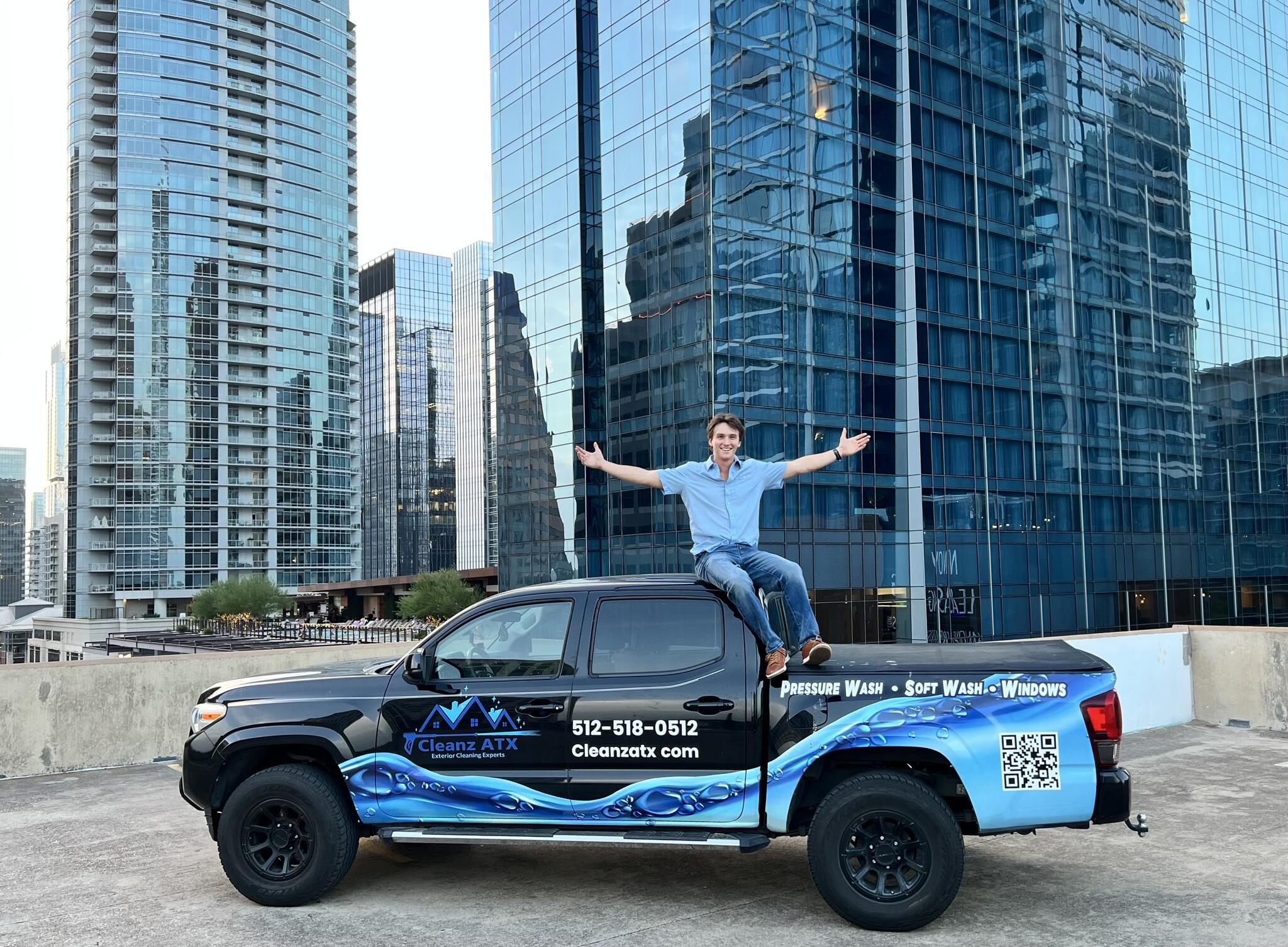 Tyler, owner of Cleanz ATX, with the company truck in downtown Austin